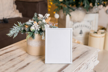 Christmas photo frame mock up template with decoration on wooden table.