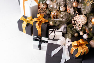 Christmas present box black, orange and white color on white floor with copy space