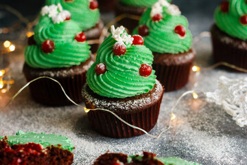 Christmas cupcakes. Spruce-shaped green cupcakes. Dessert with winter design. Delicious cupcakes
