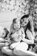 A little daughter and mother gently hug, kiss, showing love and expressing affection.Happy family, the pleasure of being a mom, congratulations on Mother's Day, the concept of a sweet moment together