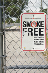 Vertical shot of a smoke-free zone sign in a school area