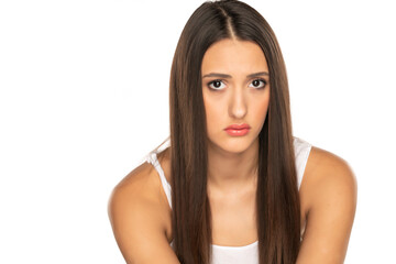 Fototapeta premium unhappy and sad young woman on a white