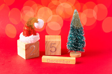 Christmas date, 25 December  on red background with xmas treer and santa claus hat. Festive...