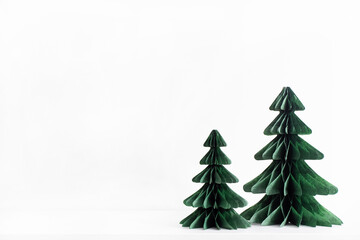 Trendy decorative Christmas trees, which made of paper with blurred house background, DIY project,...