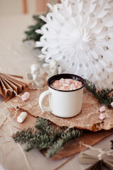 Obraz na płótnie Canvas background image with Christmas decor and a cup of cocoa with marshmallows