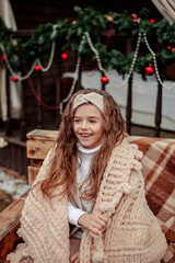 A girl in New Year decorations and with Christmas balls