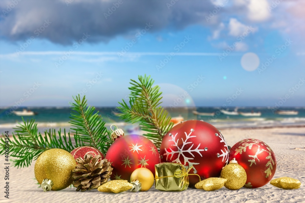 Canvas Prints Christmas toys - colored balls on the beach, blurred sea in the background. New Year or Christmas card,