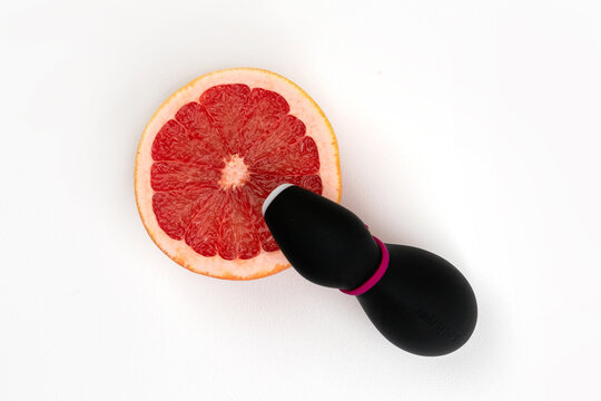 Sex toy Penguin for adult, design minimal dildo vibrator for clitoris isolated on white background. Grapefruit symbolize the female clitoris. Russia, Tatarstan, November 28, 2021 .