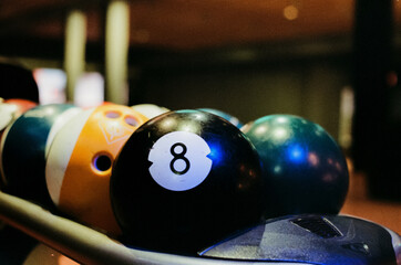 Closeup of the round black billiard ball with the number 8 - obrazy, fototapety, plakaty
