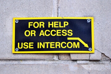 Close Up of 'Help' Sign and Arrow beside  Entrance to Building