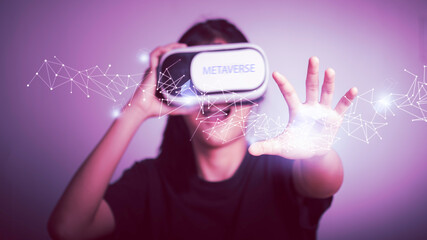 Metaverse technology in the digital world and Blockchain concept. Teenager having fun play game VR virtual reality enjoy and Experiences in  Futuristic Tone