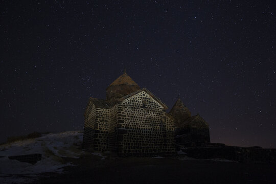 Night starry sky over the Sevanavank monastery at the northwestern shore of Lake Sevan