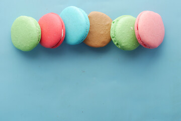 Close up of macaroon on blue background with copy space 