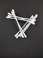 Photo of a pile of cotton buds isolated on a black background