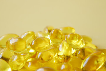 fish oil supplement on orange background 