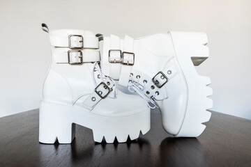 White platform boots with buckles and laces