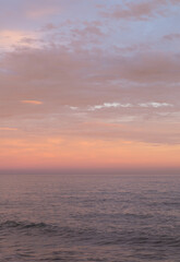 Fototapeta premium Orange, pink and lilac sunset sky in the sea. 