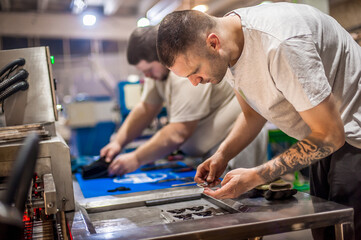 Technician making fridge magnet with soft PVC rubber in mold