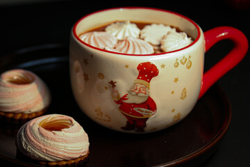 a cup of cocoa with marshmallows on a dark background