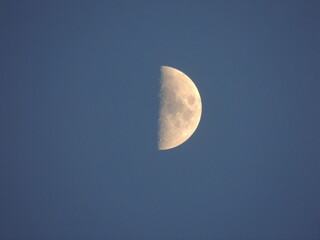 The moon on a blue background (sky). Macro photography with a zoom lens.