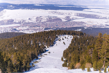 snowboarder is jumping with snowboard from snowhill. Skier skiing downhill in high mountains. Flying skier on mountains, winter extreme sport. 