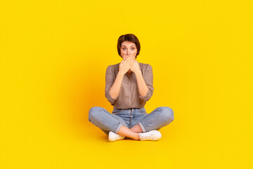Full length photo of young attractive woman sit lotus pose cover mouth hands guilty fail isolated over yellow color background