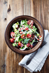 Simple Salad with Cherry Tomatoes, Lettuce, Red Pepper, Leek and Onion. Dark wooden background. Top view.