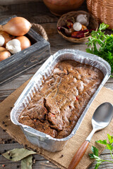 Fresh terrine from liver with onions and herbs on a cutting board