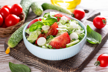 Fresh cucumber, tomato and greens salad. Spring salad