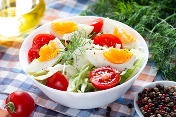 Fresh cucumber, tomato, egg and greens salad. Spring salad,