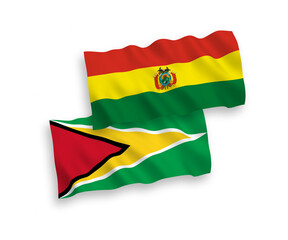 National vector fabric wave flags of Co-operative Republic of Guyana and Bolivia isolated on white background. 1 to 2 proportion.