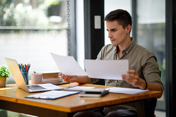 Businessman reading documents at work, Young intend and thinking busy businessman is working with a...