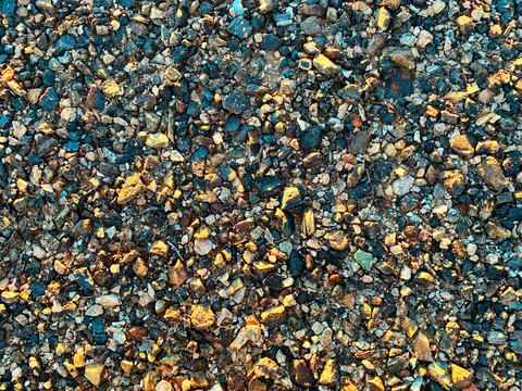 sunset shadows over dry desert rocks ground sand in evening dusk