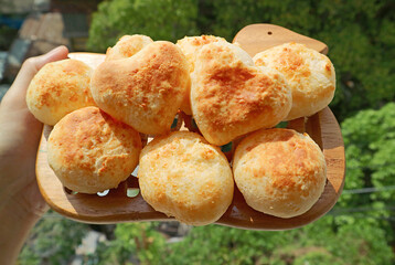 Pile of Fresh Baked Homemade Pao de Queijo or Brazilian Cheese Breads with Pair of the Heart Shaped on Top