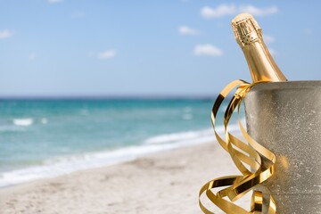 Christmas champagne of the new year 2021 on the sand on the beach