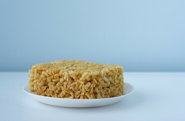 Chak chak with honey in a white plate on blue and white. National dish of Tatars and Bashkirs. Oriental sweets