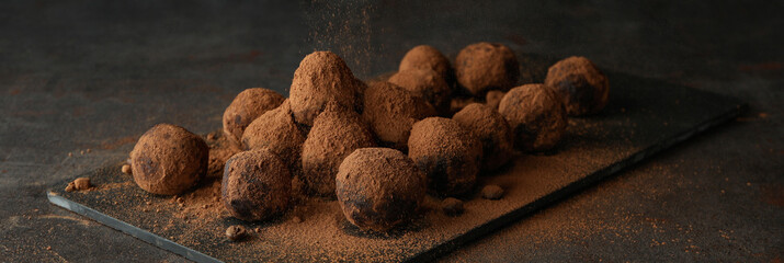 Concept of sweets with truffles on dark textured background