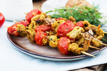 Barbecue with tomatoes on skewers. Picnic on the street
