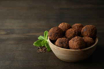 Concept of sweets with truffles on dark wooden background
