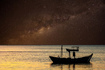 Boat anchored in the sea and starry sky. © JCLobo