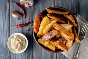Delicious baked potatoes with rosemary and thyme in a ceramic plate, close-up