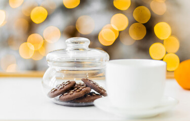 jar of chocolate chip cookies and cuo of hot drink