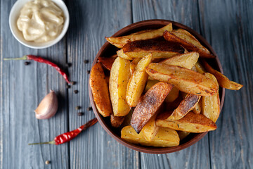 Delicious baked potatoes with rosemary and thyme in a ceramic plate, close-up