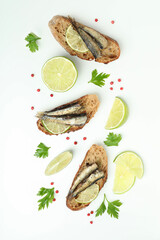 Delicious sandwiches with sprats on white background