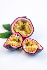 Fresh ripe passion fruits (maracuyas) on white background with water drops