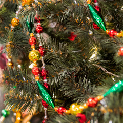 Christmas tree with shiny retro decorations. Fir tree decorated with vintage glass beads for New Year celebration.