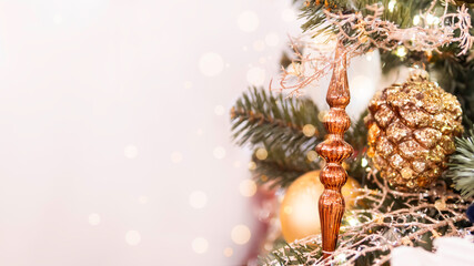 Christmas tree with shiny icicle and decorative pine cone. Fir tree decorated with light bulbs for New Year celebration. Banner with copy space.