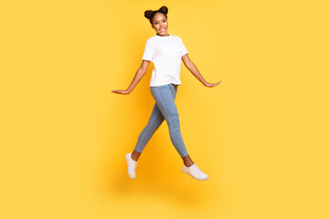 Fototapeta na wymiar Full body profile side photo of youth cheerful african girl jump up isolated over yellow color background