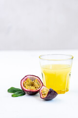 Fresh ripe passion fruits (maracuyas) on white background with water drops