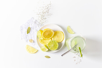 Aesthetic minimalist composition. Glass with green lemonade on white background. Summer cold drink...